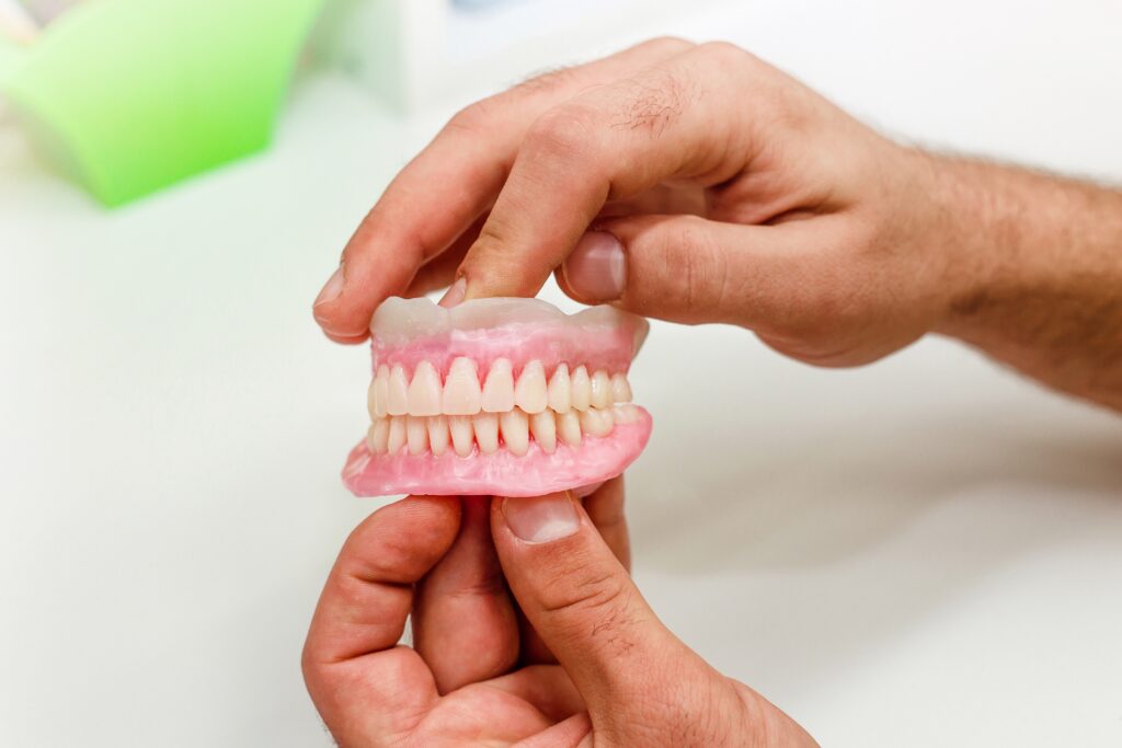 Dentist hold a mold of teeth for denture